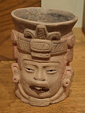 An Olmec influenced Zapotec urn from Monte Alban, in Oaxaca Mexico. It portrays a ruler or deity with facial features that appear similar to those found in the Asian cultures. Depicted with the familiar "Olmec snarl" symbolism of a snarling jaguar, and crowned with a Fleur de lis.